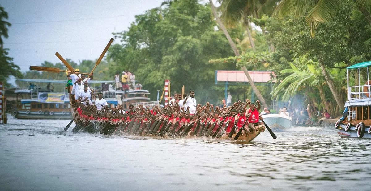 Local teams racing in a vibrant snake boat event on Punnamada Lake, an unforgettable moment in any Alleppey travel package.